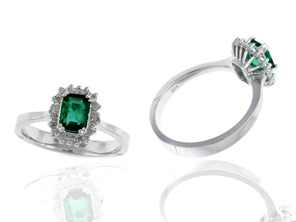 Two RW11055E rings from Ryan Gems, with 0.60ct emerald-like green gemstones and 0.18ct diamond accents in white gold, are displayed against a white background—one shown from above and the other at an angle.