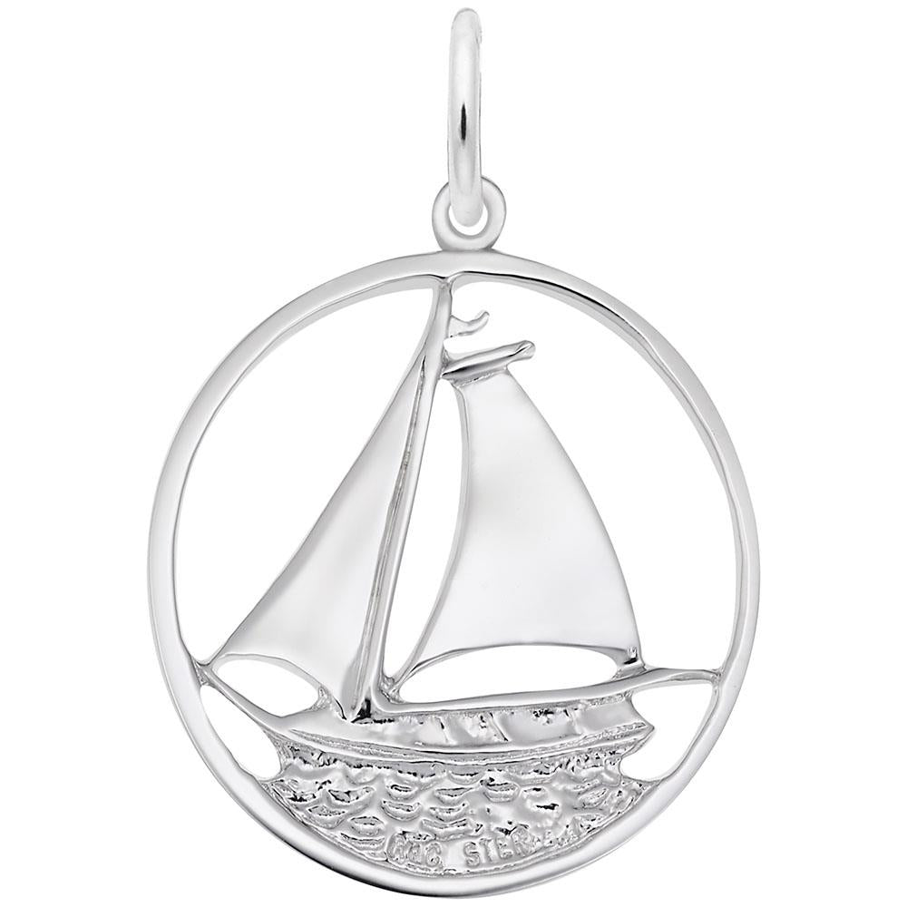 The Rembrandt Charms Sailboat Charm in sterling silver features a meticulously detailed sailboat with two sails, enclosed within a circular frame. The charm artfully captures the sailboat on textured waves, evoking a nautical theme. A loop at the top makes it easy to attach to a chain, making it an ideal piece of sailboat jewelry.
