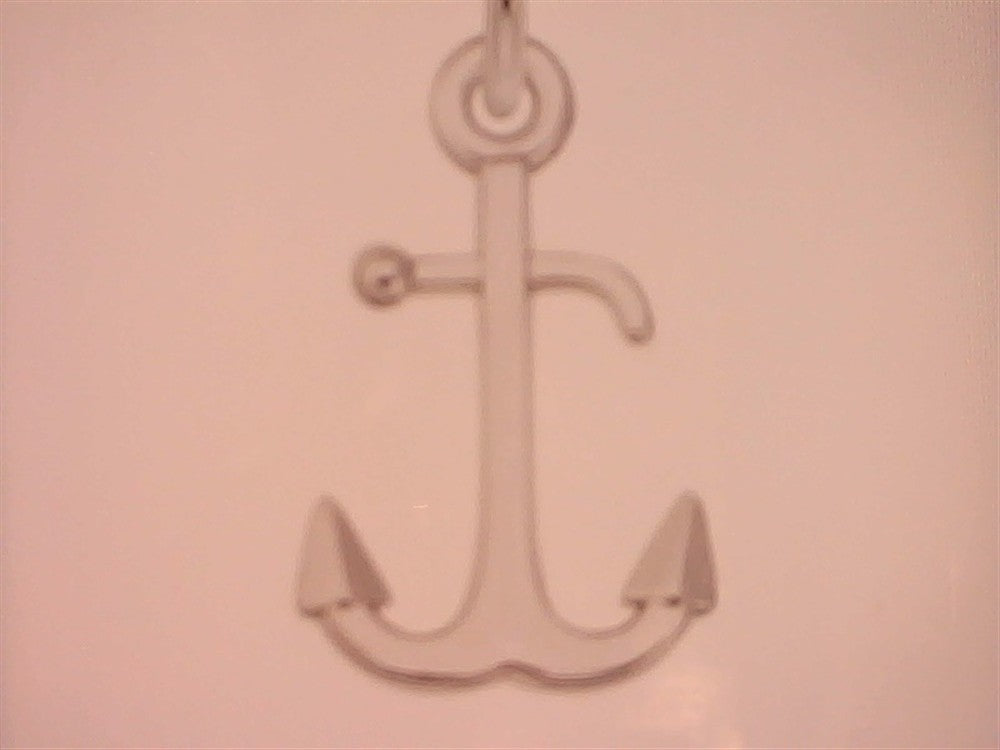 The Rembrandt Charms Anchor Sterling Silver Charm features a simple, stylized sterling silver anchor with pointed flukes and a top ring, shown against a plain, light background.