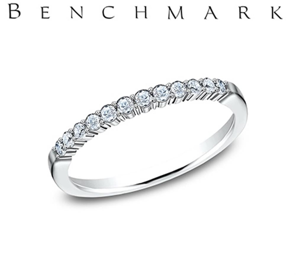 A 14K white gold ring adorned with 0.24 carats of lab-grown diamonds in a shared prong set design. The name "Benchmark Rings" is prominently displayed in capital letters above the band. The ring is showcased against a white background.