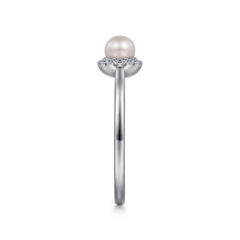 Side view of the Gabriel & Co 14K White Gold Pearl Ring with Diamond Halo, showcasing a round center pearl encircled by diamonds on a slim band, displayed against a white background.