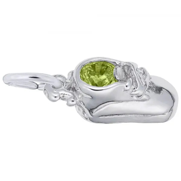 The August Baby Shoe Charm / Sterling Silver by Rembrandt Charms features a green gemstone at its center. The charm is intricately designed with details resembling the laces and seams of a real shoe, and it has a loop at the back for attaching to a bracelet or necklace.