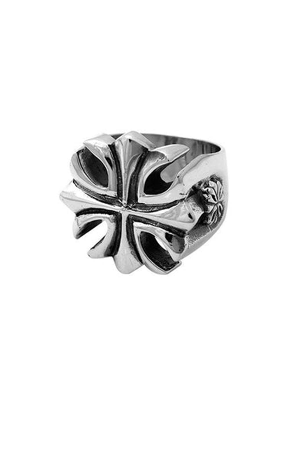 The Gothic Cross Silver Ring by King Baby is a sterling silver masterpiece with a bold, raised design showcasing a stylized Gothic cross on its face. This handmade-in-USA piece boasts a chunky and prominent form, with intricate details extending onto the band for a striking appearance. The background is plain white.