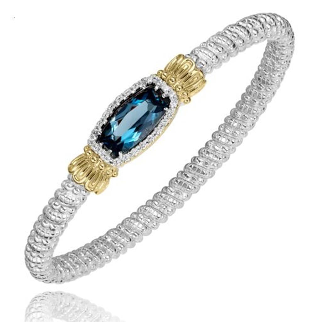 Introducing the London Blue Topaz and Diamonds 4mm Vahan by Alwand Vahan Jewelry: a stunning silver bracelet displaying an intricate braided design, adorned with a central London blue topaz gemstone. This exquisite topaz is encircled by an ornate 14k gold setting, embellished with detailed accents on either side and enhanced by diamond accents totaling 0.24 carats. An epitome of elegance and sophistication.