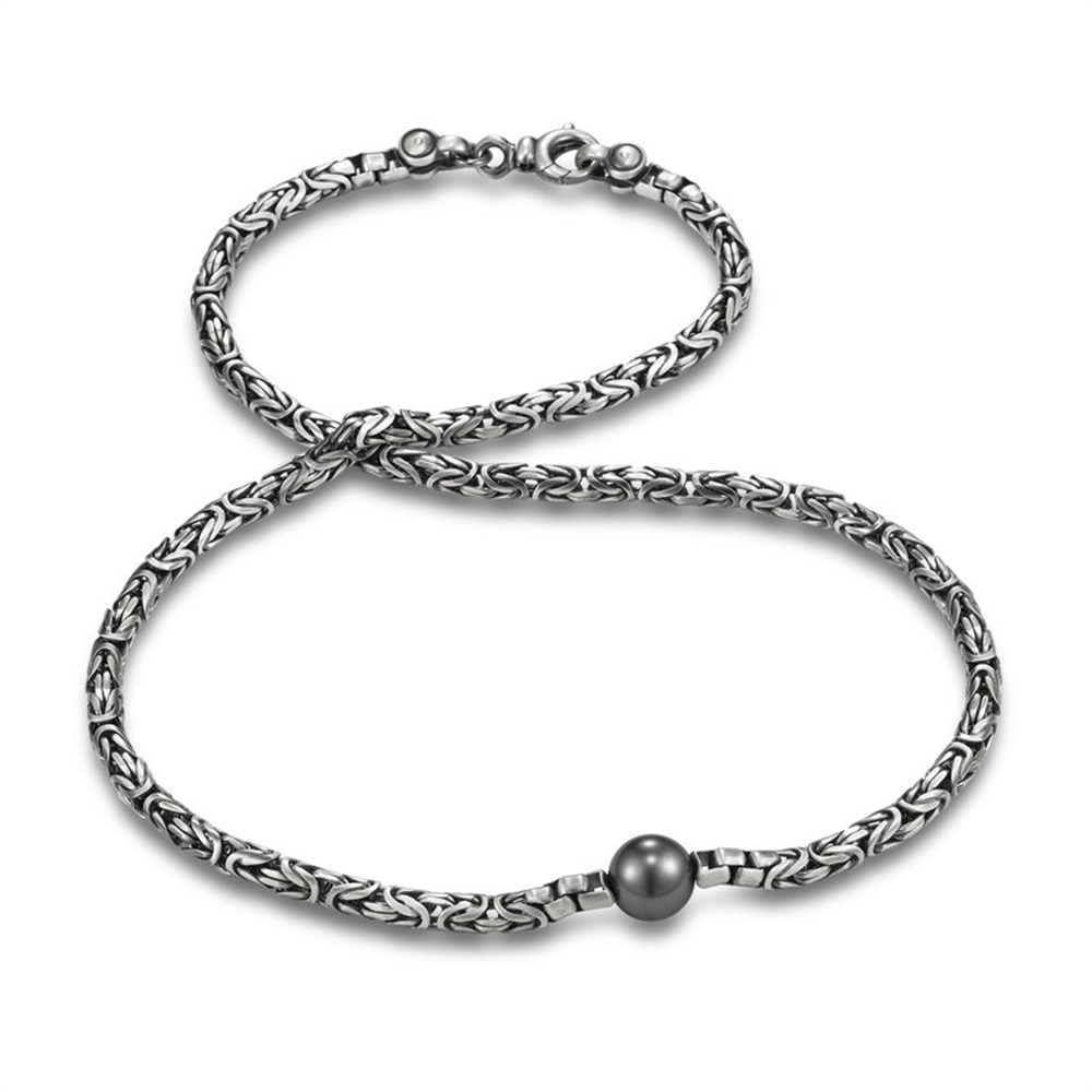 The Mastoloni Pearls Tahitian Pearl with 22" Sterling Silver Chain features a striking central pearl on an elegant woven chain, displayed on a white background—adding timeless charm to any outfit.