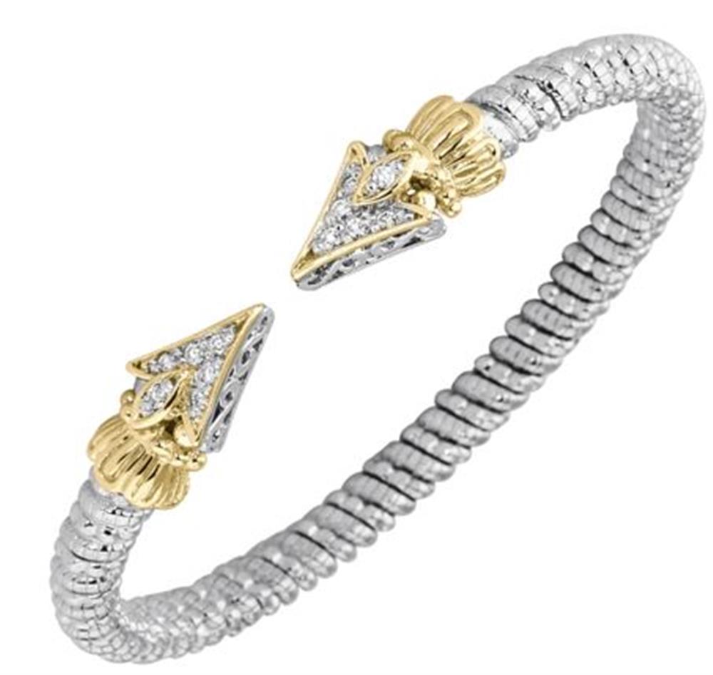The Alwand Vahan Jewelry 4MM Band 0.19ct / Size B / 22229D04 is a sophisticated silver braided bracelet with gold arrow-shaped ends. Each end is adorned with intricate gold detailing and sparkling diamonds totaling 0.19ct. The flexible, open-ended design elegantly combines silver and gold elements for a timeless look, while Size B ensures a perfect fit.
