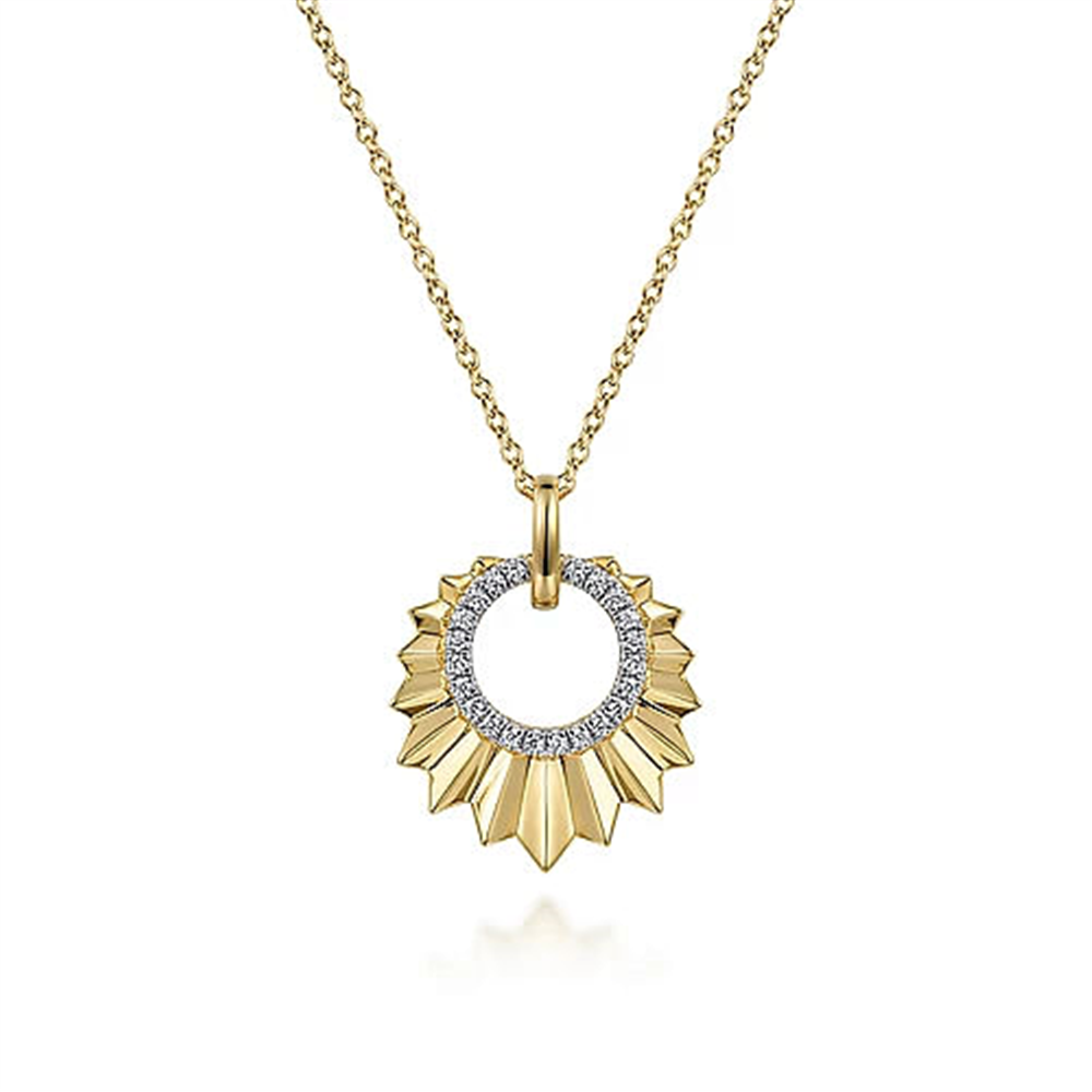The Gabriel & Co 14K Yellow Gold Diamond and Diamond Cut Texture Pendant Necklace boasts a luxurious sunburst design. The circular pendant, adorned with an inner ring of sparkling diamonds, radiates golden rays, making it a truly stunning piece.