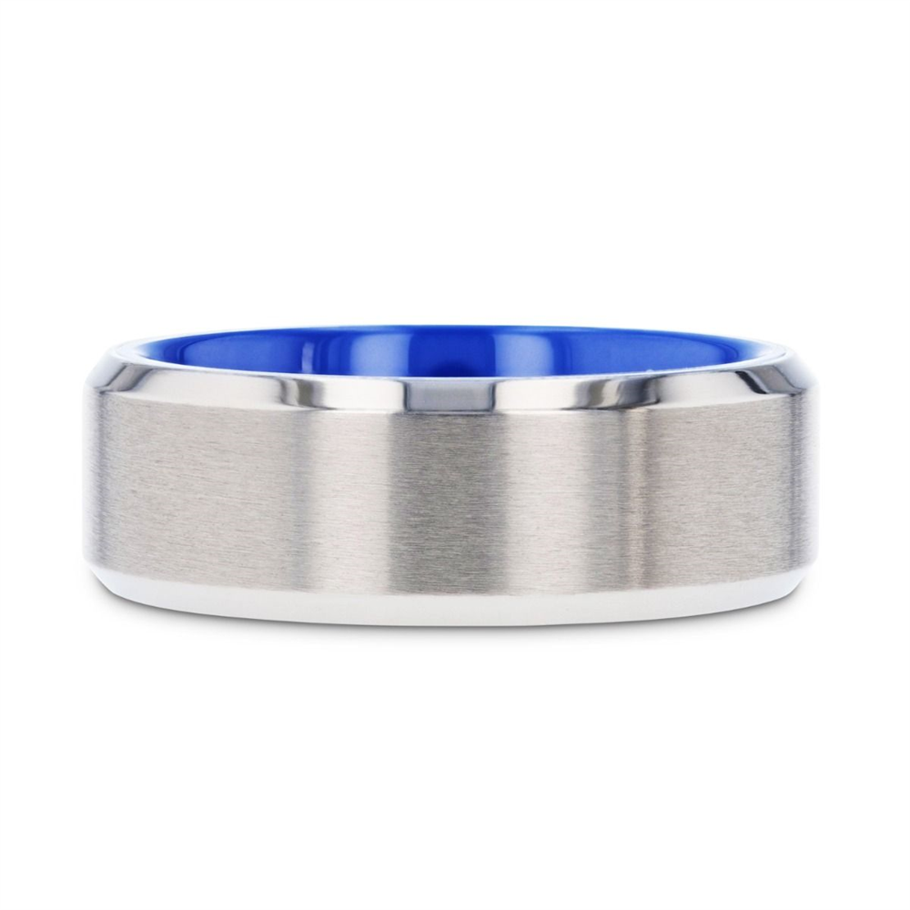 The ARCTIC Flat Beveled Edges Titanium Ring with Brushed Center and Vibrant Blue Interior by Thorsten features a brushed metal exterior with beveled edges and a shiny, polished silver finish. Inside, the vibrant blue contrasts beautifully with the metallic surface. This ring boasts a modern, sleek design and is crafted from durable material.