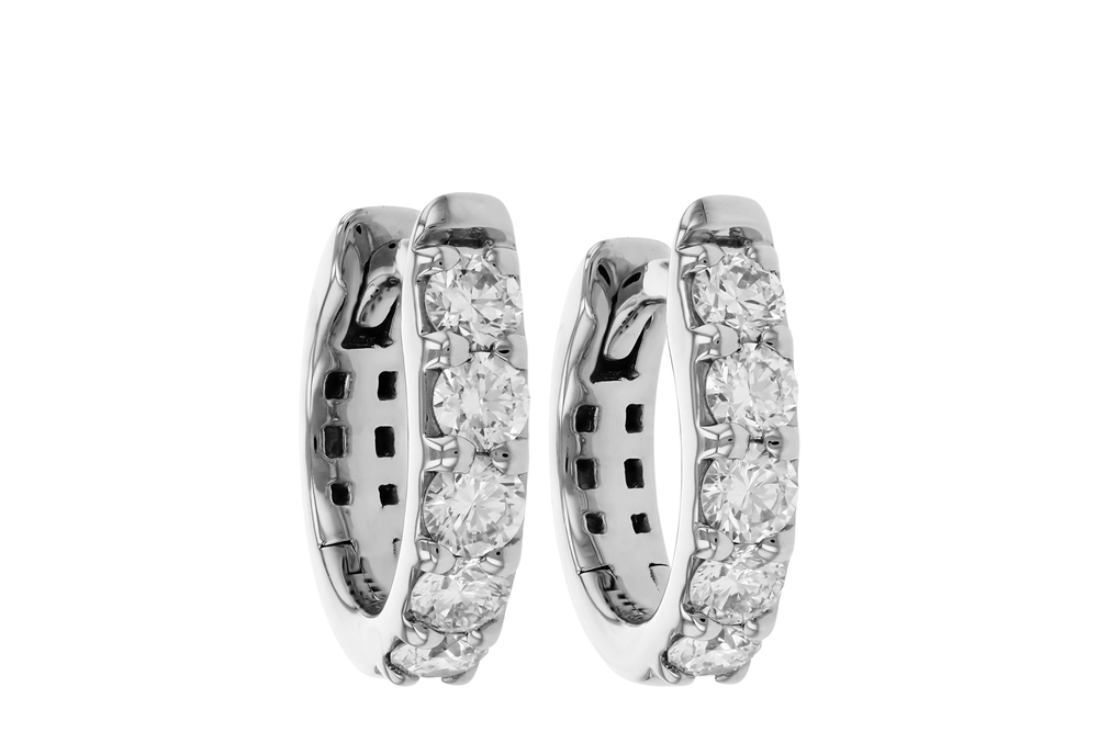 A pair of Allison Kaufman 14k white gold huggie hoops, each featuring five round natural diamonds totaling 0.50ctw set in a row along the front outer edge.