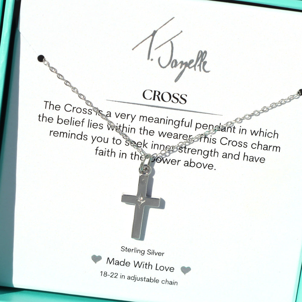 The T Jazelle Cross CZ Sterling Silver Charm Necklace features a cross charm on an adjustable sterling silver chain, presented in a turquoise box with a card explaining its meaning and the phrase "Made With Love.