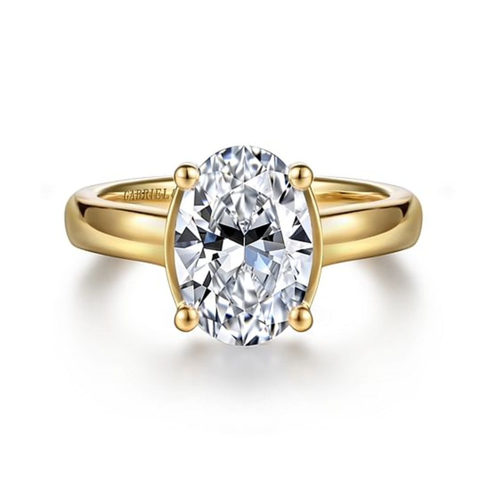 The Gabriel & Co 14K Yellow Gold Half Bezel Oval Diamond Engagement Ring (HEAD - 10.5X7) features a striking oval-cut diamond set in yellow gold, showcased against a white background.