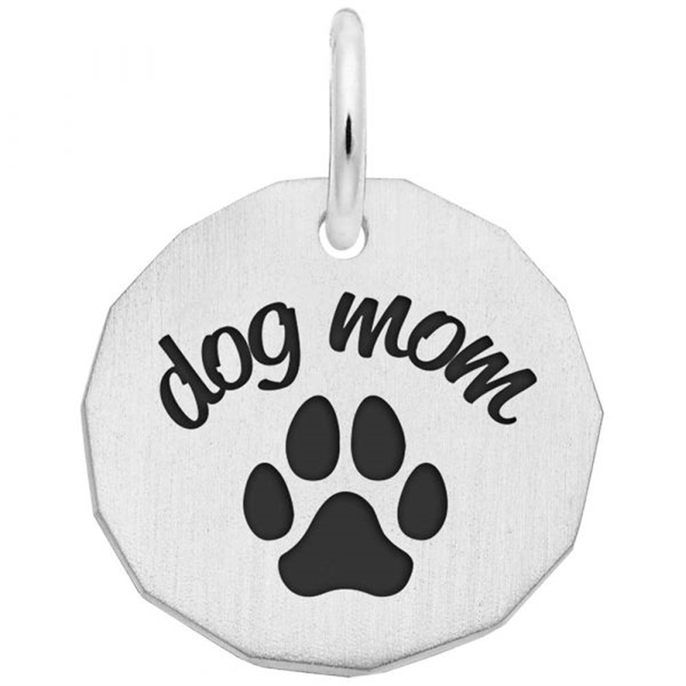 The "dog mom - sterling silver charm" by Rembrandt Charms features the words “dog mom” above a black paw print on a circular, slightly faceted sterling silver pendant with a top loop for your chain.