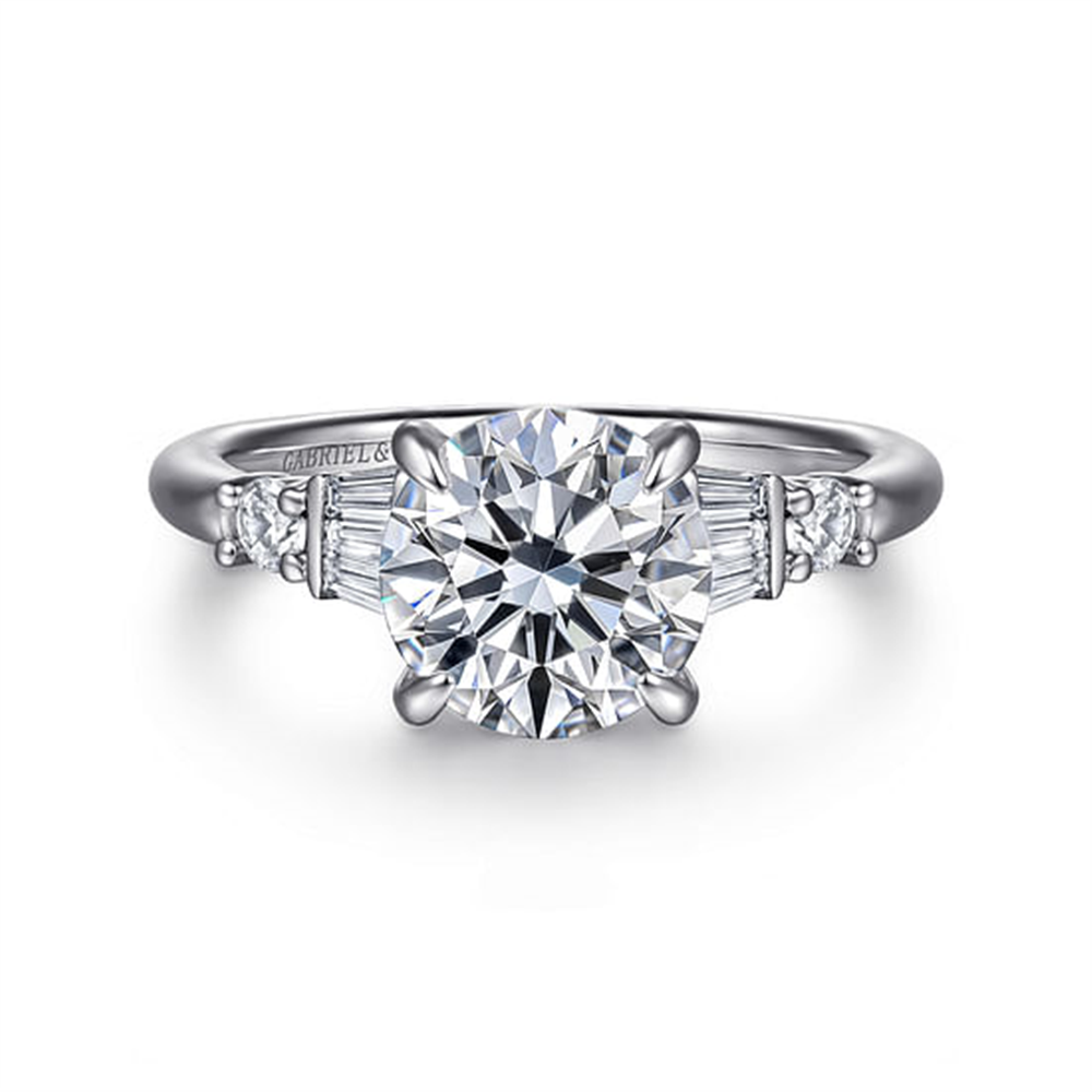 The Gabriel & Co 14K White Gold Round Diamond Engagement Ring (SN: S2079331) features a prominent round center diamond, baguette-cut side diamonds, and small round diamond accents along the band.