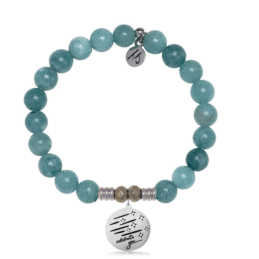The Mountain Blue Jade Gemstone Bracelet with Birthday Wishes Sterling Silver by T Jazelle features teal round beads, two small silver beads, a sterling silver charm engraved with stars, lines, "celebrate," and a small round tag with initials.