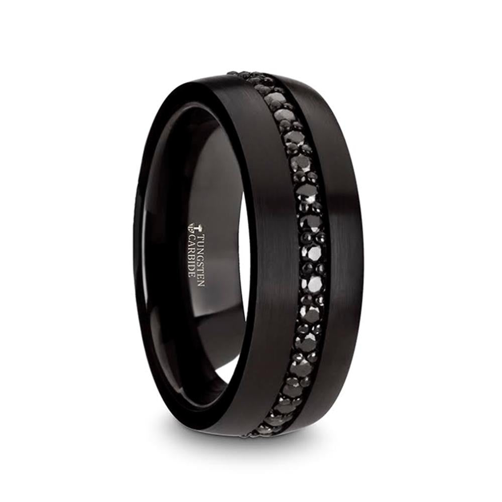 The Black Tungsten with Black Sapphires Band by Thorsten features a central band adorned with small black sapphires. The stones are set in a single line that encircles the entire ring, contrasting beautifully against the smooth, matte finish of the tungsten band.