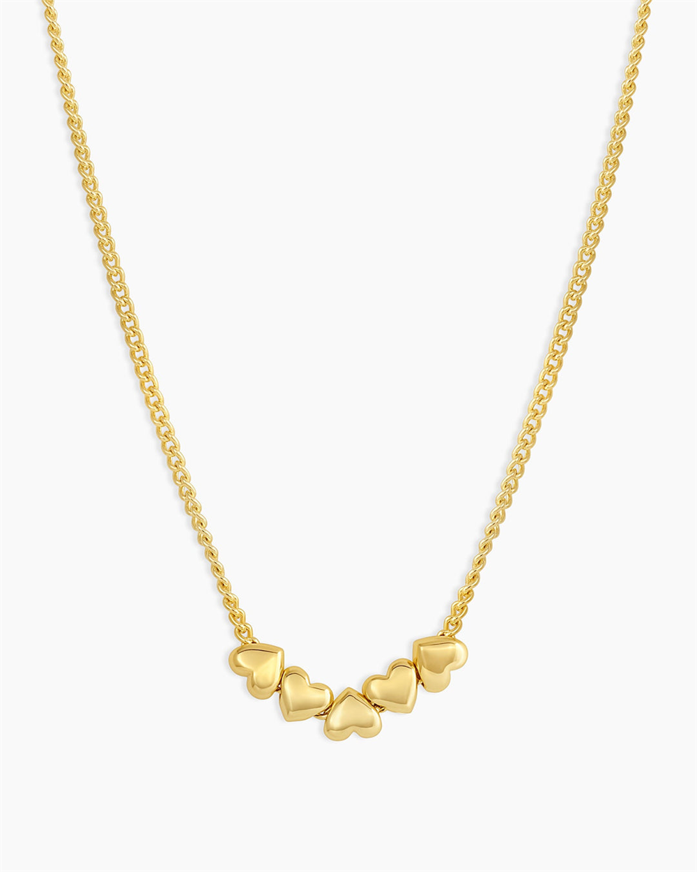 The Lou Heart Necklace by Gorjana features five small gold heart charms clustered on a delicate 18k gold plated chain—a stylish piece perfect for everyday elegance.