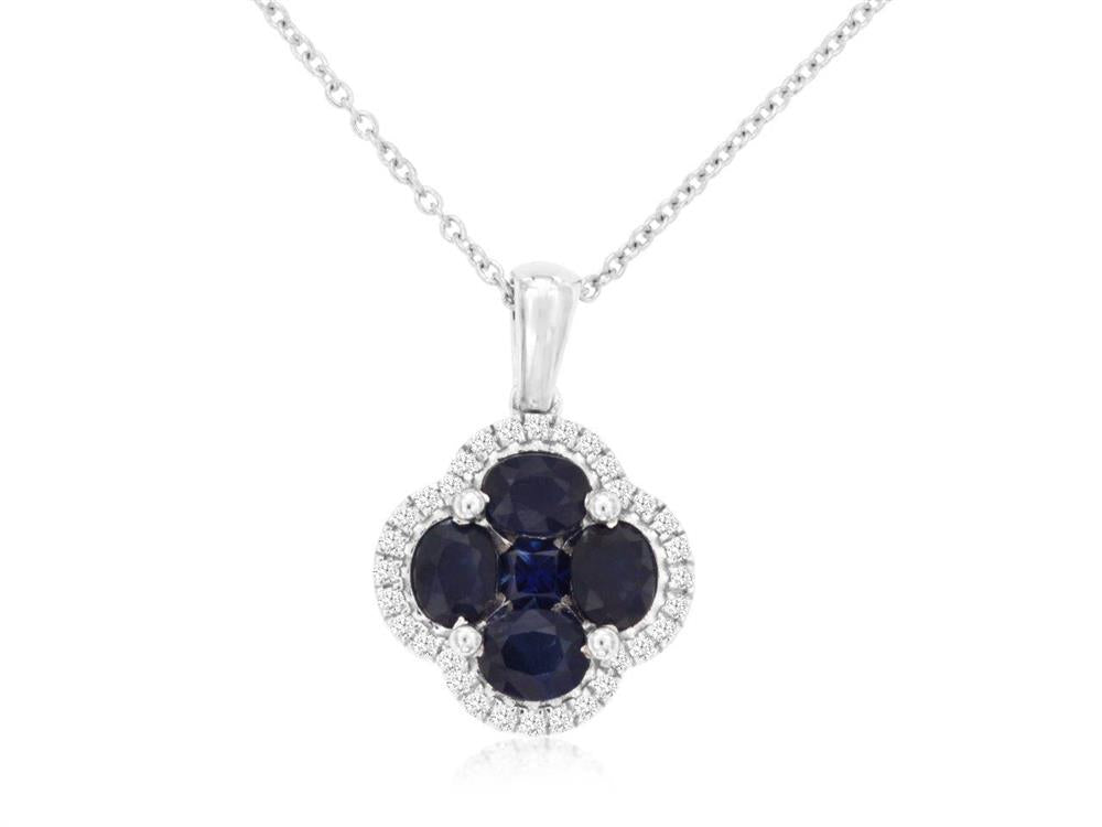 The Royal Jewelry 14K White Gold Sapphire and Diamond Clover Pendant features a sapphire pendant with four oval dark blue gemstones in a diamond clover shape, surrounded by small stones. The simple chain enhances its timeless elegance.