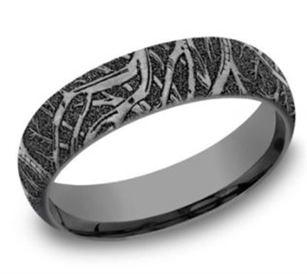 The 6mm "Dark Doomed Enchanted Forest" tantalum ring by Benchmark Rings features a black, intricate tree branch pattern etched around the band. The detailed design contrasts with the smooth silver surface, creating a unique, organic appearance reminiscent of its enchanting namesake. The plain white background accentuates the ring's texture and design, ensuring it stands out.