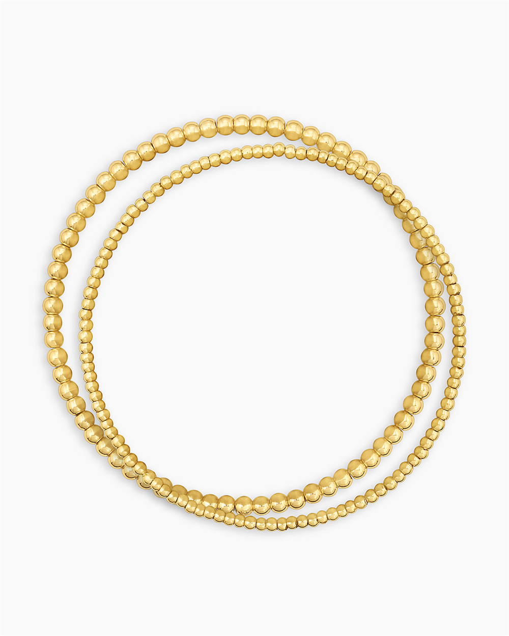 Three strands of 18k gold plated bead necklaces with varying bead sizes and a polished finish. Perfect to pair with the Gorjana Poppy Gold Bracelet Set for a chic, coordinated look.