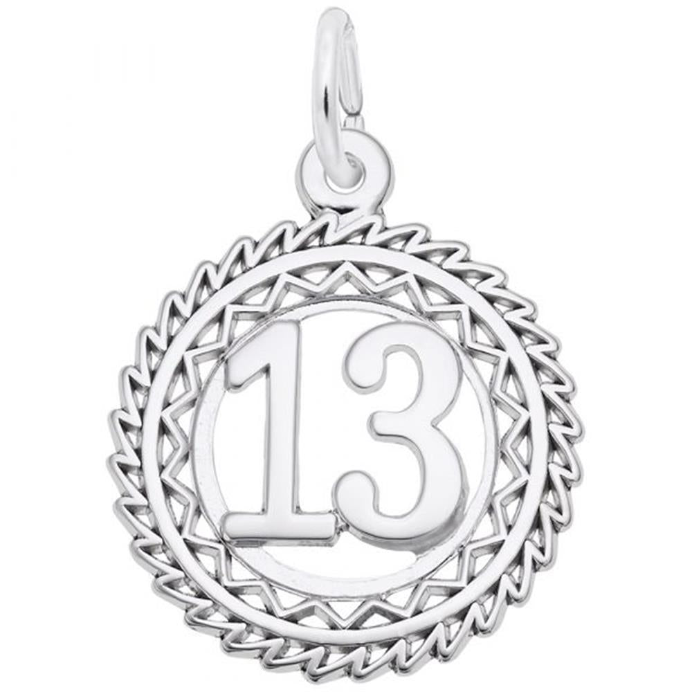 The Rembrandt Charms Number 13 Charm is crafted from sterling silver and features the number 13 in the center, surrounded by an intricate zigzagged border. The symmetrical design includes a loop at the top for easy attachment to a necklace or bracelet, and is polished to give it a shiny, reflective finish.