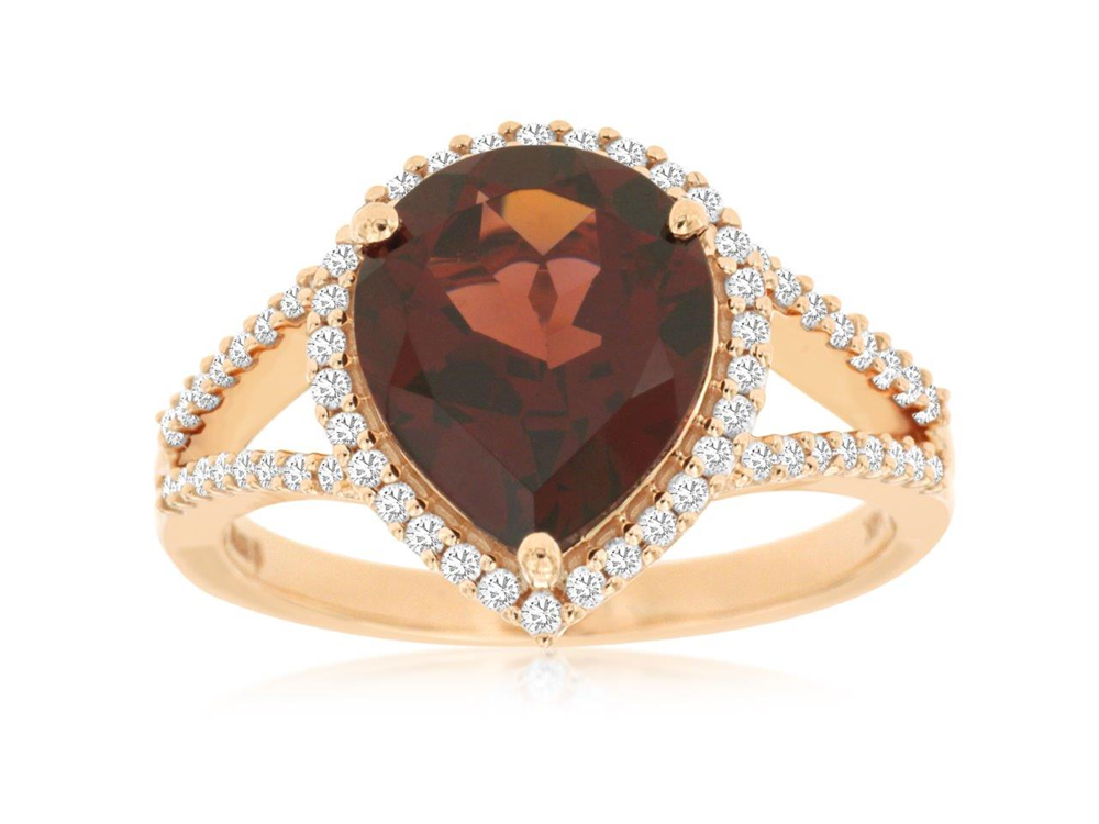 A stunning 14k rose gold ring, style #PC6545G by Royal Jewelry, features a teardrop-shaped garnet center framed by white gemstones. The split band glistens with classic diamond-like stones.