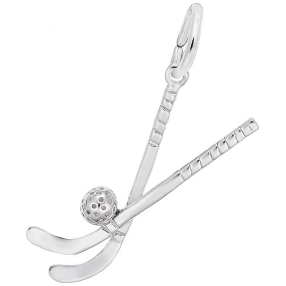 The Field Hockey Sticks With Ball Charm in Sterling Silver by Rembrandt Charms showcases two intersecting hockey sticks with tape details on the handles and a small, textured hockey ball at their intersection. It includes a loop at the top for easy attachment to a bracelet or necklace.