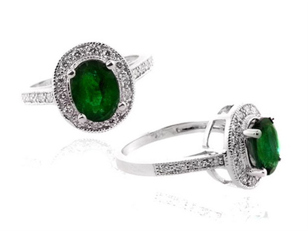 Two Ryan Gems rings, RWSP8831E model, feature oval 1.70ct emerald centers encircled by 0.31ct diamonds in a white gold setting. One is shown upright for the top view; the other is angled to reveal side details.
