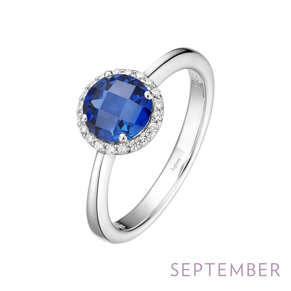 A silver September Birthstone Ring by Lafonn features a large, round blue gemstone in the center, surrounded by smaller clear stones in a halo setting. The word "SEPTEMBER" is written in light purple text at the bottom right of the image, indicating this stunning piece as a September birthstone.