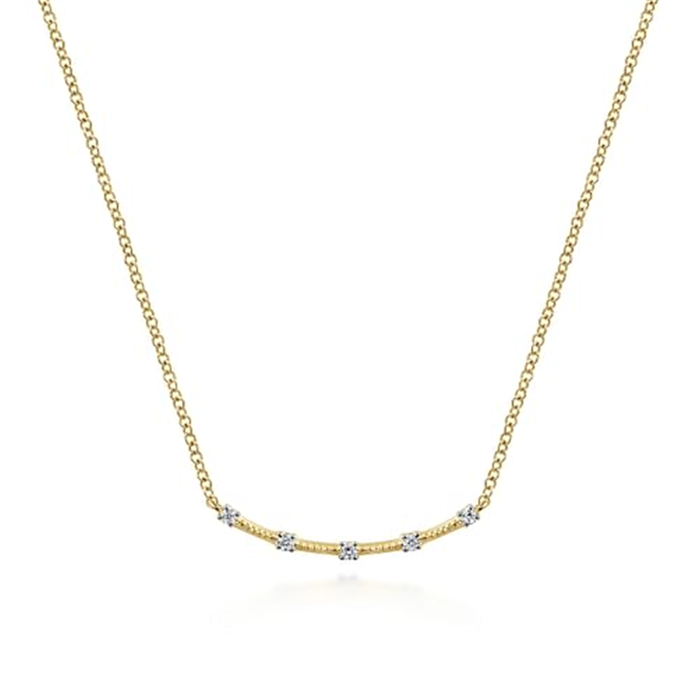 The Gabriel & Co 14k yellow gold diamond station bar necklace from our Contemporary Collection features a delicate chain with a curved bar pendant. It is adorned with five evenly spaced, small white gemstones, creating a simple yet elegant design that highlights the shimmer of the stones and gold's warmth.