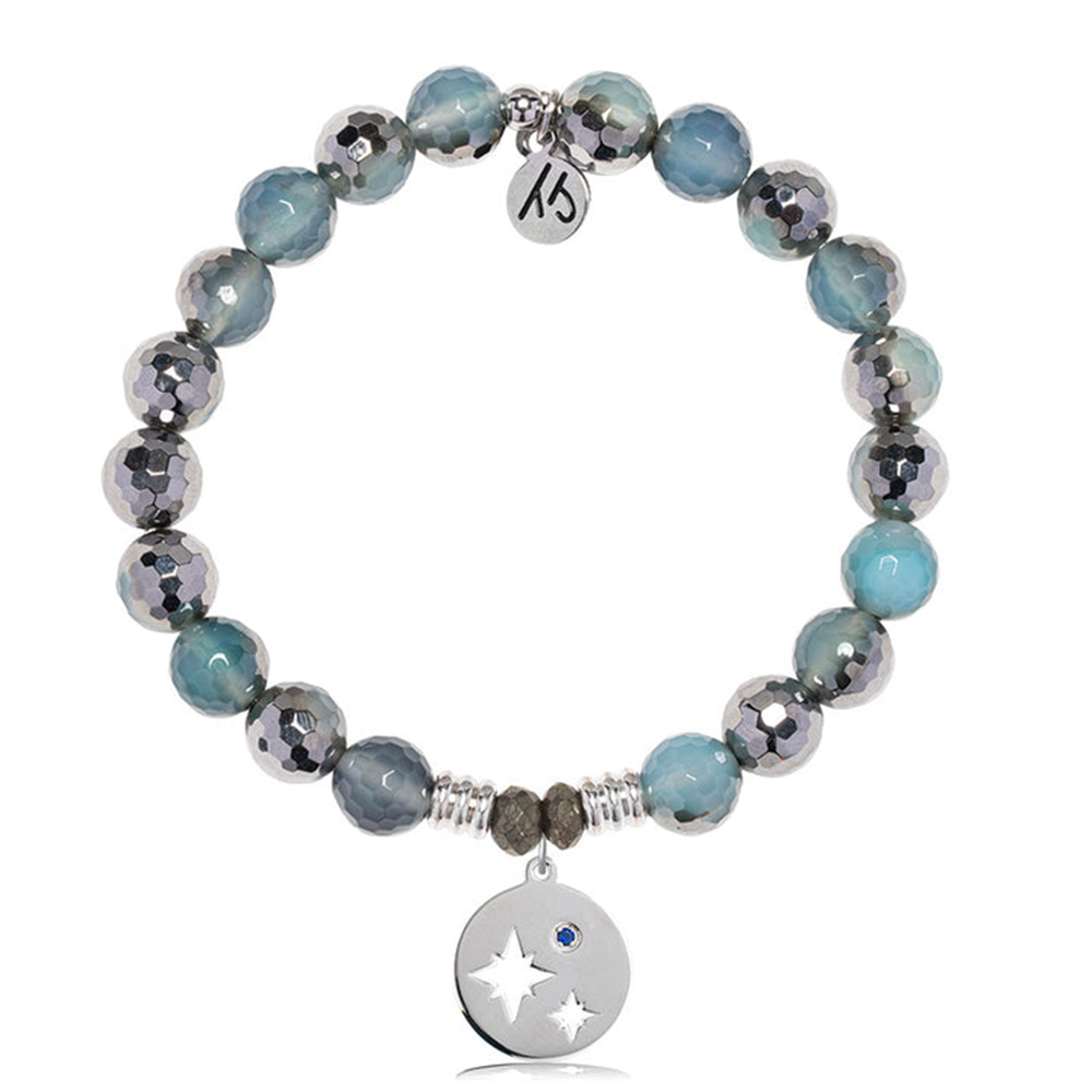 The T Jazelle Blue Silver Agate Gemstone Bracelet features alternating blue and silver beads, a sterling silver Mother Son charm with star and moon cutouts, a blue gemstone, and an engraved tag—perfect as a Mother Son bracelet.