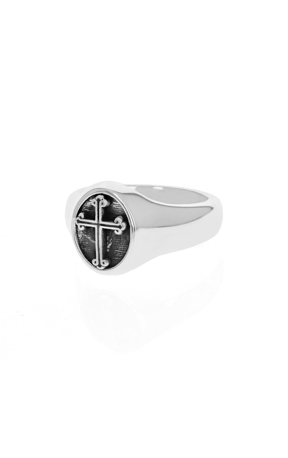 The Traditional Cross Silver Ring by King Baby is a polished and reflective signet ring showcasing a black circular face with an intricate cross design, set against a plain white background.
