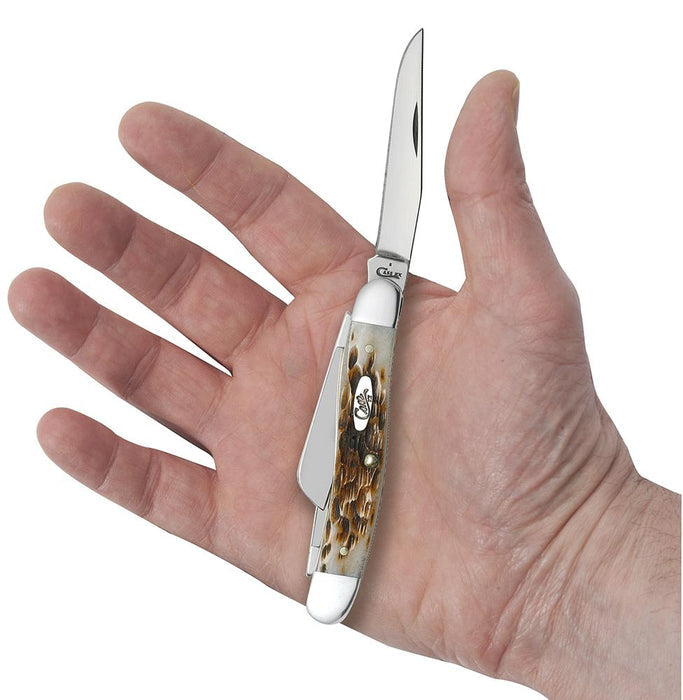 A hand holding an open Medium Stockman Knife from W.R. Case & Sons Cutlery Co., showcasing a polished Tru-Sharp™ stainless steel blade and an intricately textured Amber Bone handle with a blend of brown and white colors. The handle also proudly displays the brand's emblem or logo.