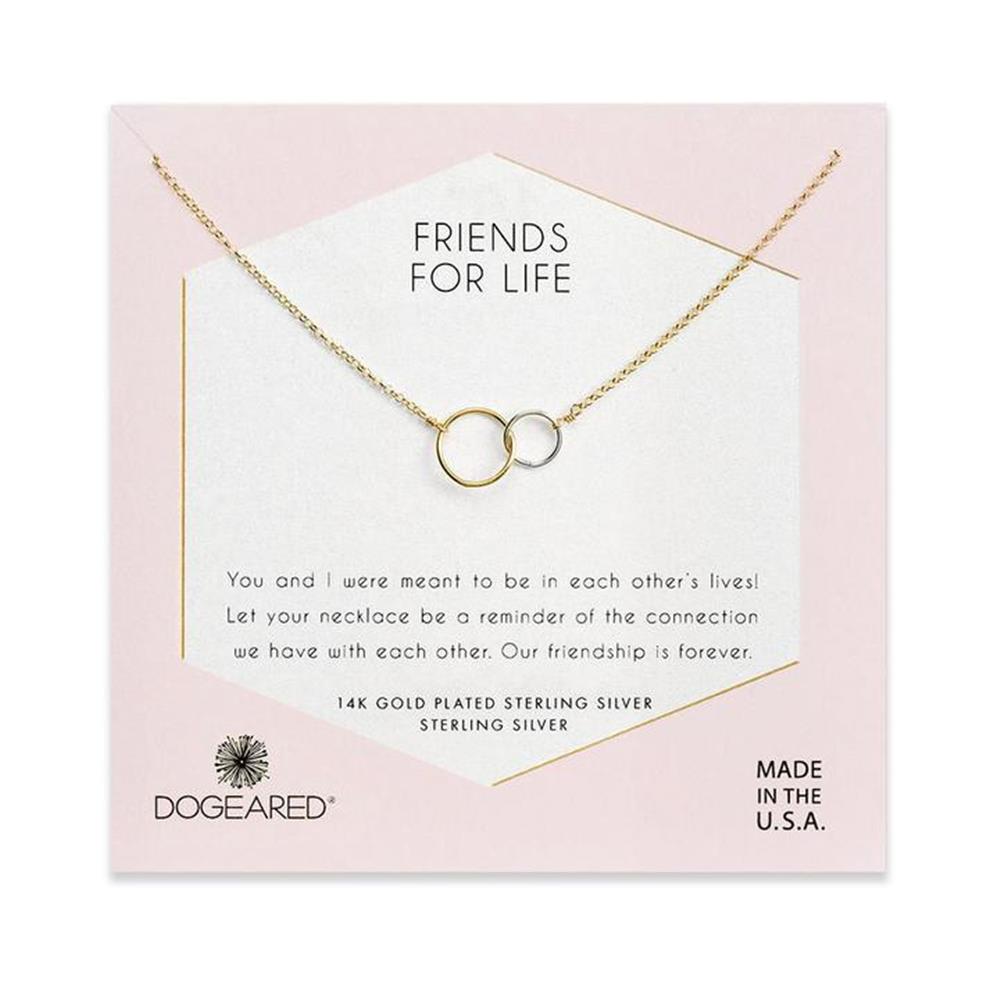 An elegant 18" necklace by Dogeared, featuring two interlocking circle pendants—one gold and one silver—delicately displayed on a card that reads "Friends For Life." The card contains a heartfelt friendship message and states that the Friends For Life / GP-SS necklace is made in the USA.