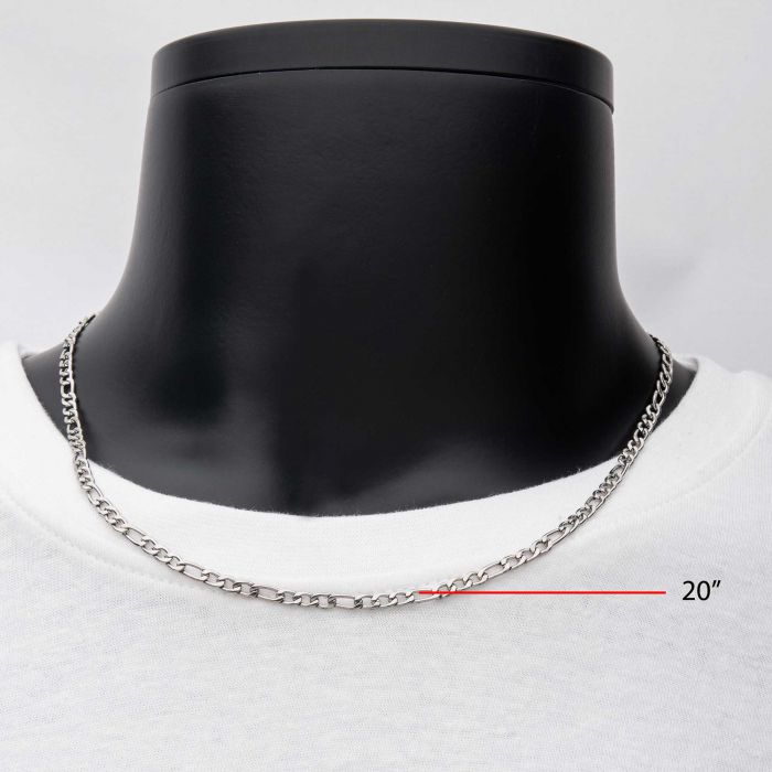 A 4mm Steel Figaro Chain from INOX is displayed on a black mannequin bust. The stainless steel chain rests elegantly on a white T-shirt, accompanied by a measurement line indicating its length of 24 inches.