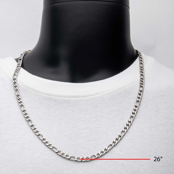 A 6mm Steel Figaro Chain from INOX, measuring 24 inches long, is elegantly displayed on a black mannequin bust wearing a white shirt. This men's stainless steel necklace is clearly indicated by a measurement line and text at the bottom right corner of the image.