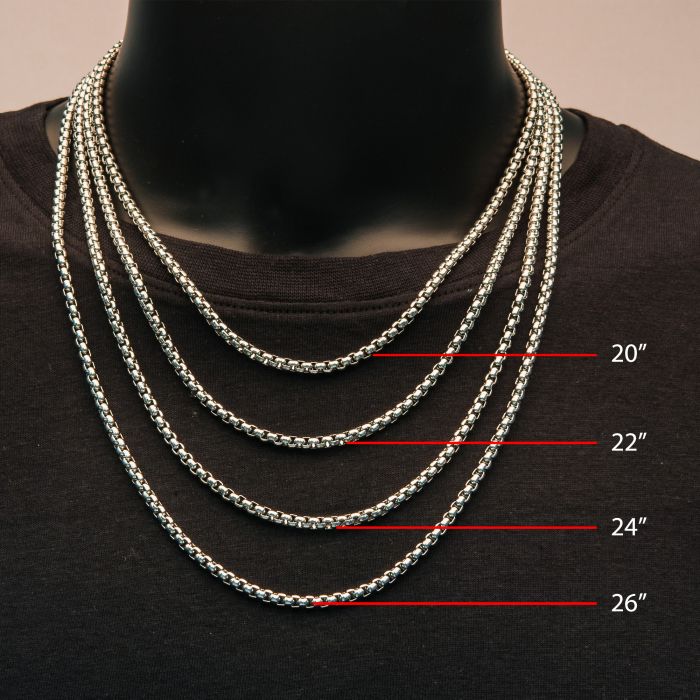 Four INOX steel bold box chain necklaces are displayed on a black mannequin torso, each labeled with red text indicating their lengths: 20 inches, 22 inches, 24 inches, and 26 inches from top to bottom. These stainless steel men's necklaces feature a sleek box chain design and complement the black shirt worn by the mannequin.