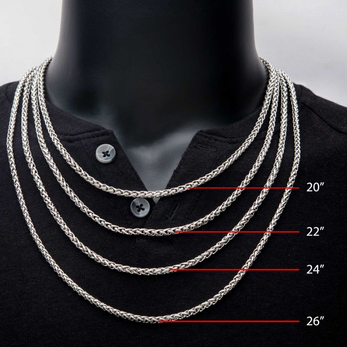 Close-up of a person wearing a black shirt, showcasing five different lengths of the 4mm Steel Wheat Chain Necklace by INOX around their neck. Each chain is labeled with its length: 20 inches, 22 inches, 24 inches, 26 inches, and 28 inches.
