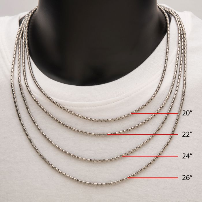 A display of four INOX men's 3mm stainless steel Boston Link chains of varying lengths on a black mannequin dressed in a white shirt. Each necklace is distinctly labeled with its respective length: 20 inches, 22 inches, 24 inches, and 26 inches. These elegant chains from the INOX collection offer versatile style for any occasion.