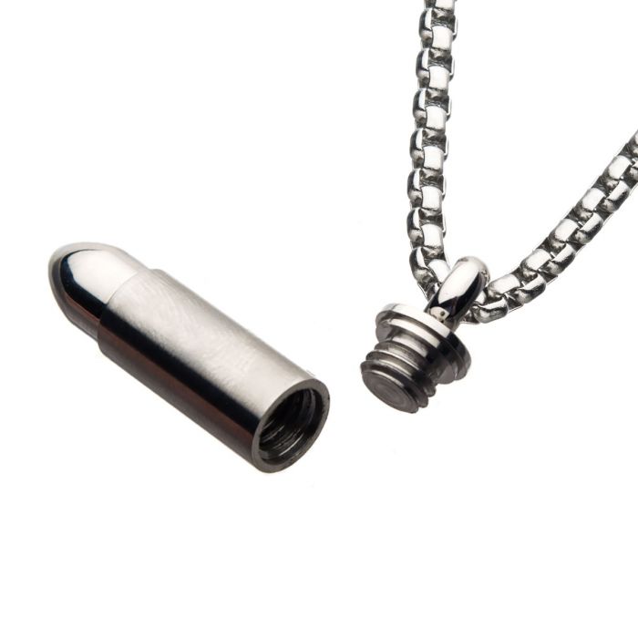 The INOX Stainless Steel Memorial Bullet Pendant features a sleek bullet-shaped design and comes with a small, separate screw-on cap. Attached to a thick silver box chain, this stylish men's pendant is hollow and designed to securely hold small items or keepsakes.