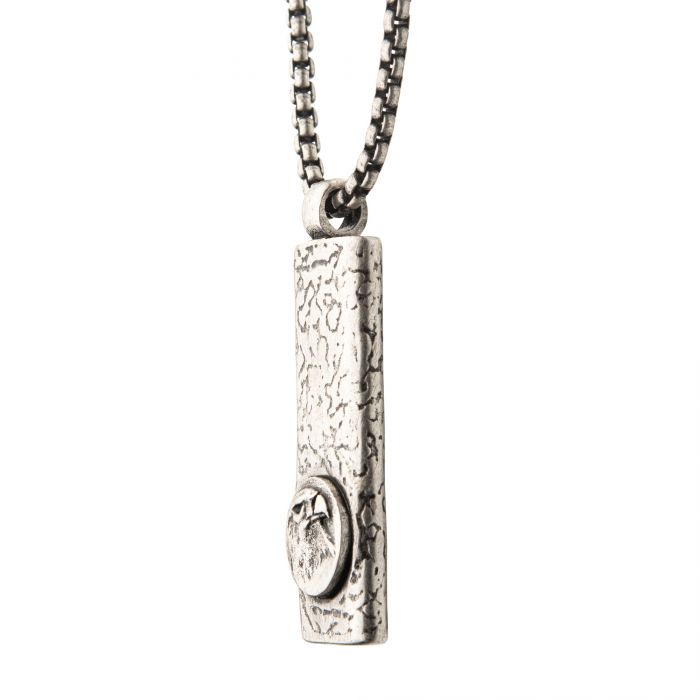 A close-up image of the Stainless Steel Silver Plated Dog Tag Pendant with an Eagle Head Inlay, hanging from a steel box chain. The rectangular pendant from INOX showcases an oval emblem featuring a stylized eagle head in relief.