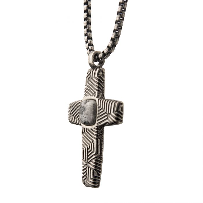 The INOX Stainless Steel Silver Plated Cross Pendant with a Gray Jasper Stone is elegantly hanging from a steel box chain, showcasing intricate geometric patterns and a polished jasper stone at its center, which adds a touch of contrast to the detailed design.