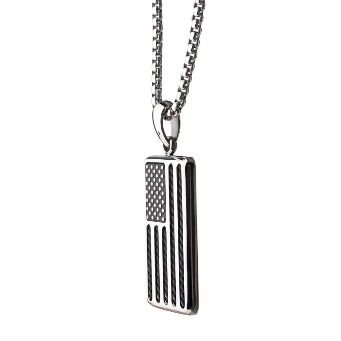 The American Flag Stainless Steel Enamel Pendant from INOX features an engraved American flag design with alternating black and white stripes and stars. This bold rectangular men's necklace pendant hangs elegantly from a 24" box chain, set against a plain white background.