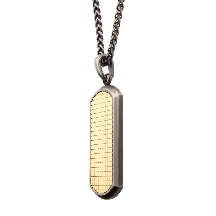 The Gun Metal Plated Pendant with 18K Gold on Wheat Chain by INOX features a 24" wheat chain and a rectangular pendant. The pendant boasts an 18K gold-plated, textured grid-patterned surface on one side, highlighted by smooth silver edges. The chain is finished in a sleek, dark gun metal polish.