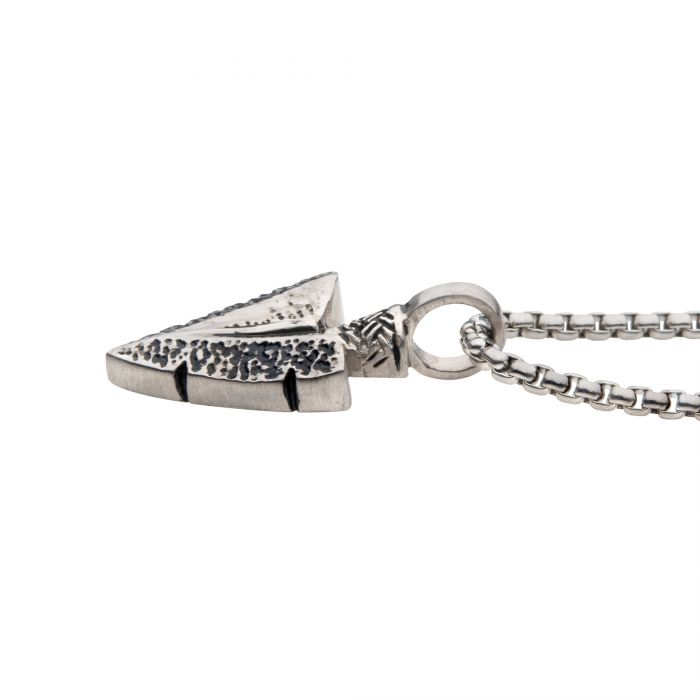 The Antiqued Steel Arrowhead Pendant with Bold Box Chain by INOX features a men's arrowhead pendant with darkened indentations that highlight its intricate design. The 22-inch chain complements the textured pendant, creating a striking look with its simple, even-linked construction that ensures both durability and style.