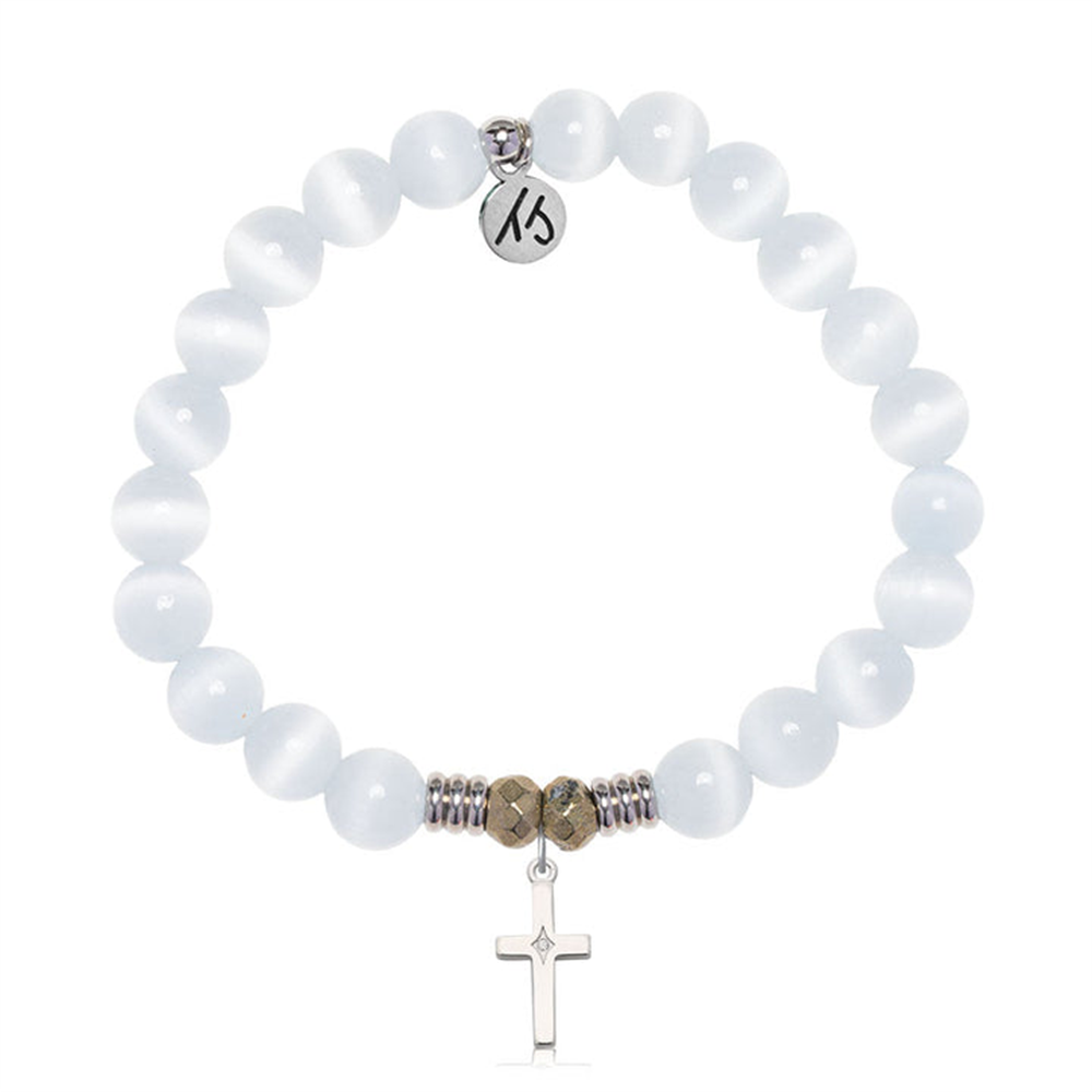 The T Jazelle White Cats Eye Gemstone Bracelet features round white cat’s eye beads, metallic accents, a sterling silver cross with CZ charm, and is elegantly displayed on a white background.
