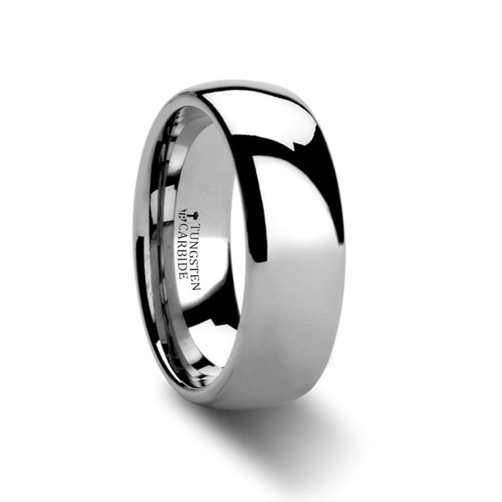 A polished 7mm Thorsten DOMINUS Domed Tungsten Carbide Ring in Size 9.50, featuring a smooth, reflective surface. The inside of the band is engraved with "TUNGSTEN CARBIDE." The ring is beautifully displayed against a white background.