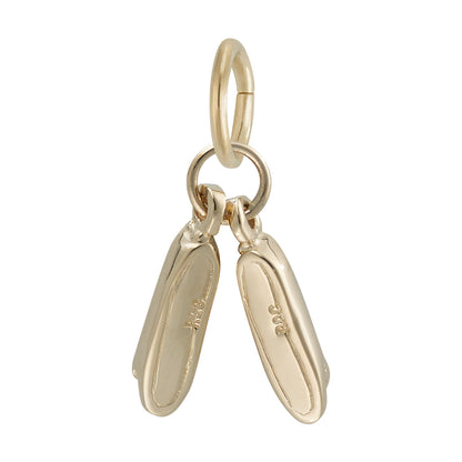 The Rembrandt Charms Pair of Ballet Shoes Charm - Gold Plated features two intricately detailed ballet slipper pendants hanging side by side from a small circular loop, ideal for attaching to a bracelet or necklace—making it a perfect dance gift or ballet shoe charm.