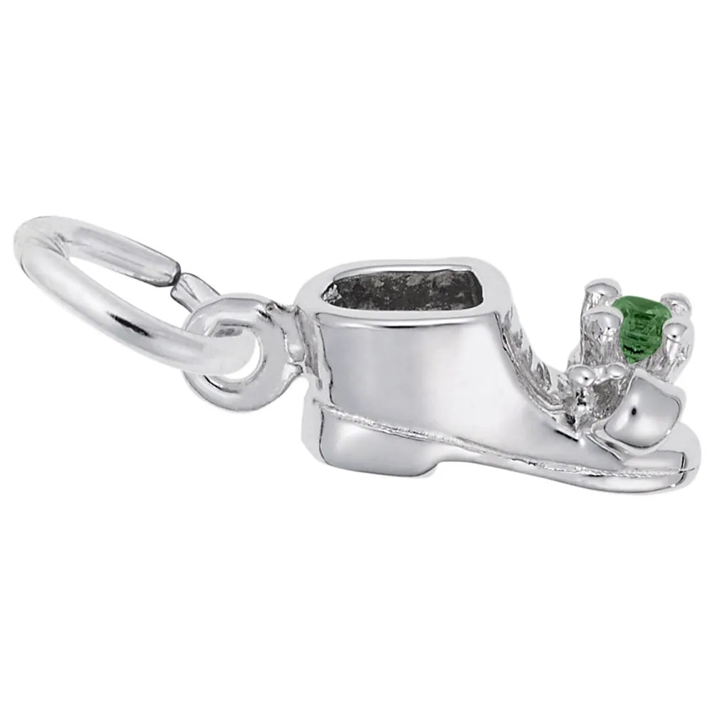 The May Baby Bootie Charm by Rembrandt Charms is a sterling silver charm with intricate detailing, featuring a green gemstone at the heel. It includes a loop for attaching to a bracelet or necklace.