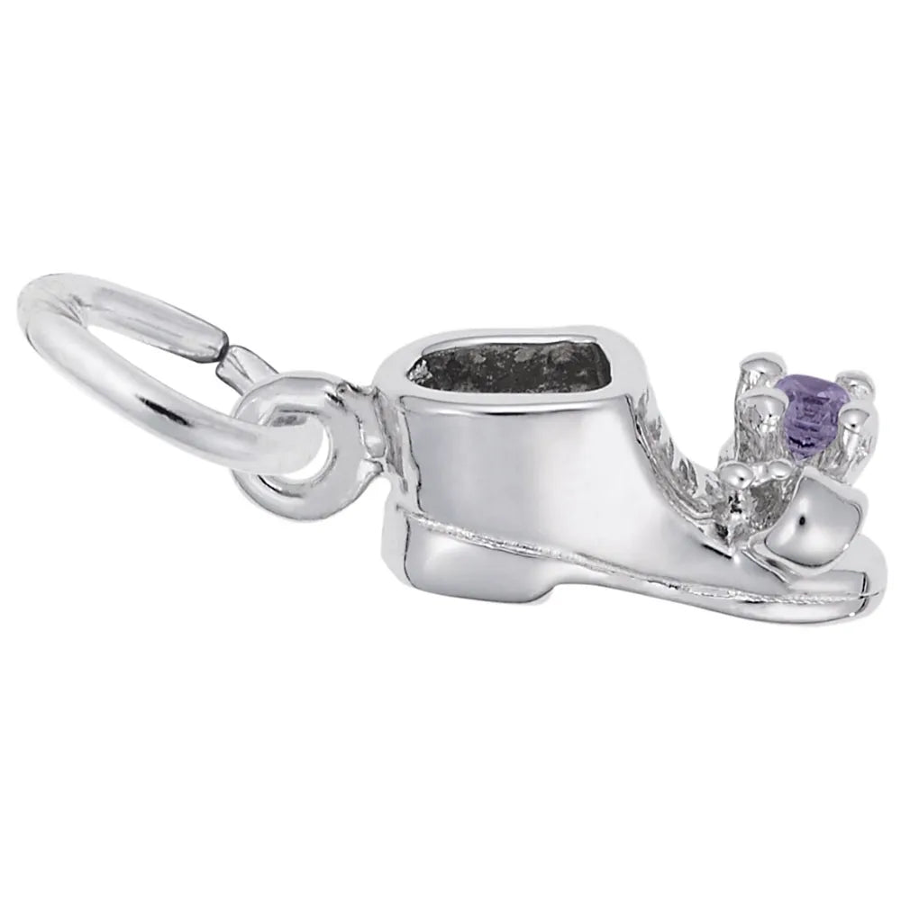 A close-up image of the June Baby Bootie Charm in sterling silver by Rembrandt Charms. This baby shoe-shaped charm showcases detailed stitching and a smooth finish. A small loop at one end allows for easy attachment to a bracelet or necklace, while a purple gemstone is elegantly embedded near the toe.