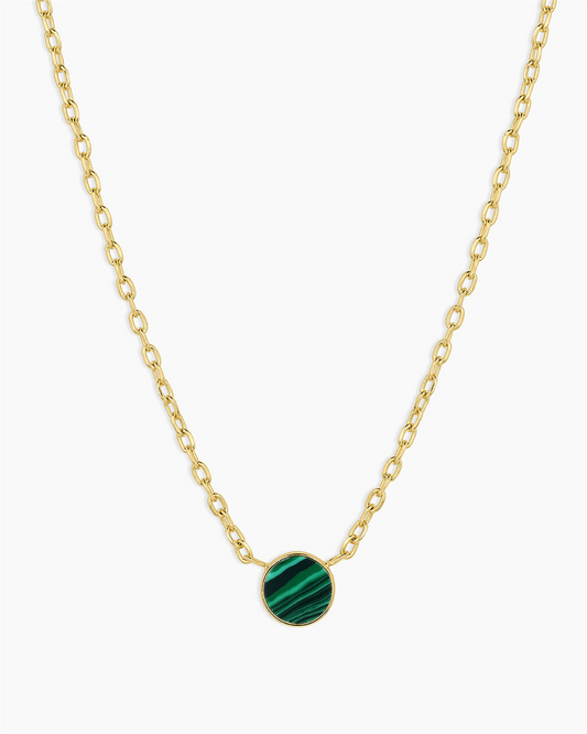 The Gorjana Rose Marble Coin Necklace - Malachite features an 18k gold plated chain with a round green malachite pendant, showcasing subtle stripes and centered on the necklace.